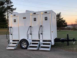 The Elegant Model luxury bathroom trailer with 2 stalls featuring marble countertops and premium
                fixtures